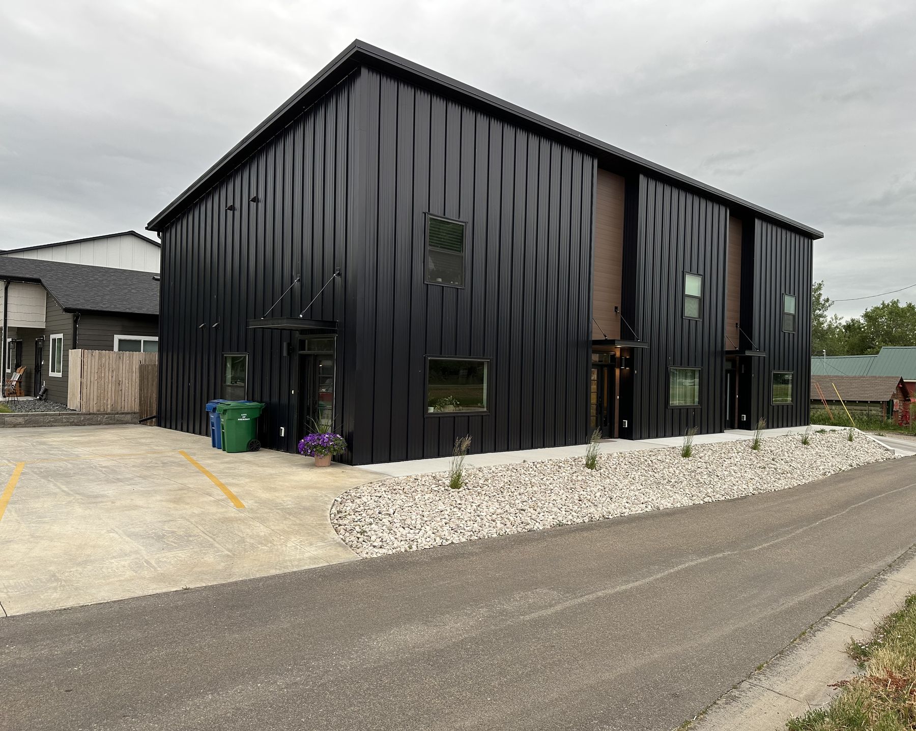 Black metal-sided modern building built by Build It Brothers
