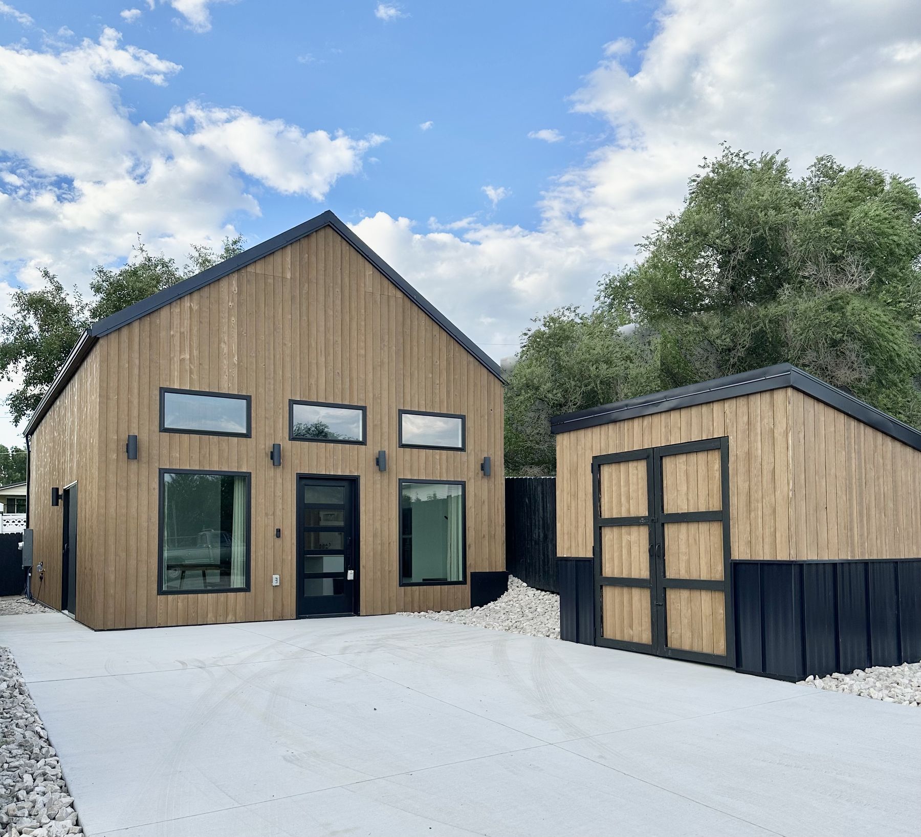 Modern cedar-sided home and matching shed built by Build It Brothers