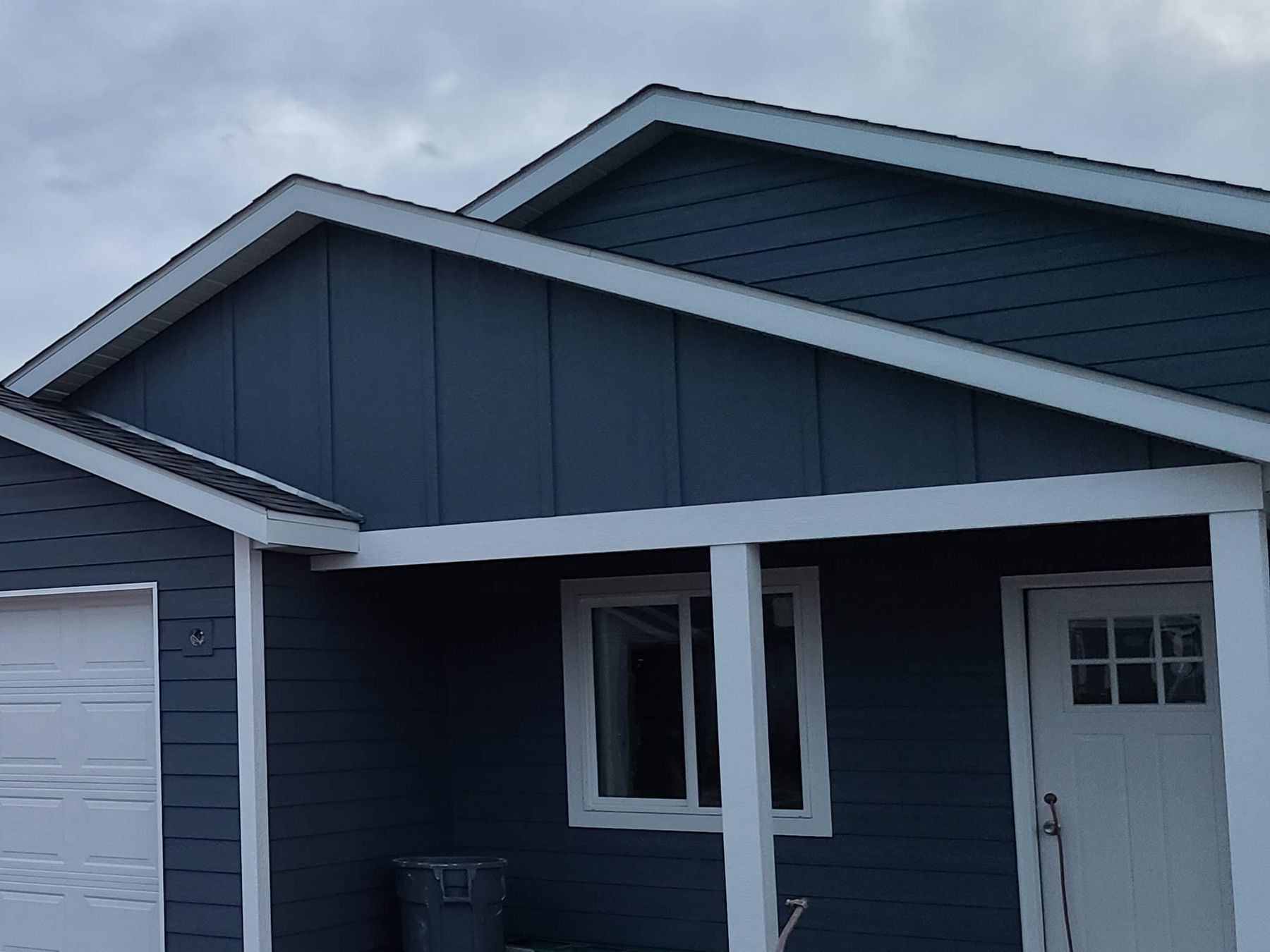 Blue single-story home with white trim built by Build It Brothers