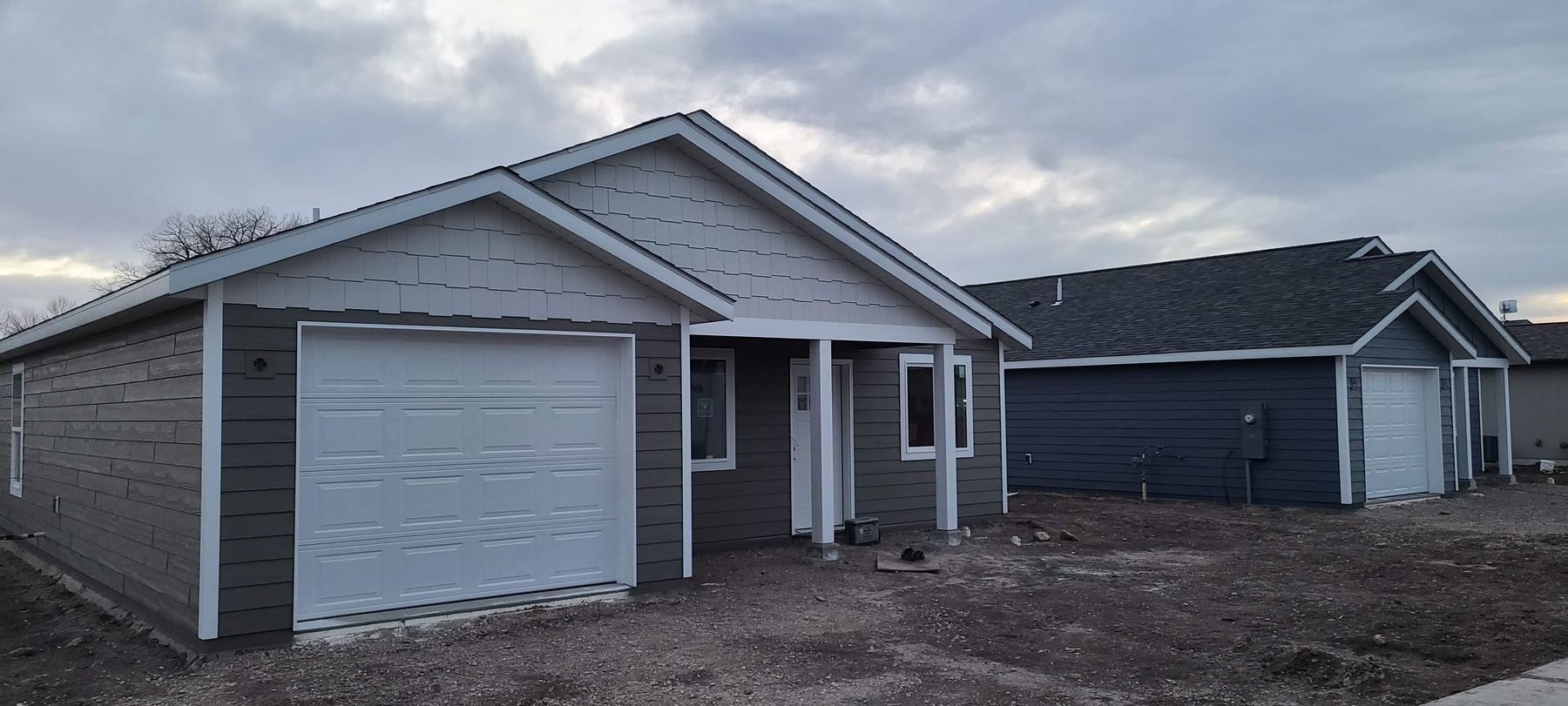 Gray single-story home with front porch built by Build It Brothers
